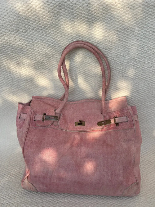 Blossom pink washed leather Firkin tote bag photographed in natural sunlight, showing its vintage finish