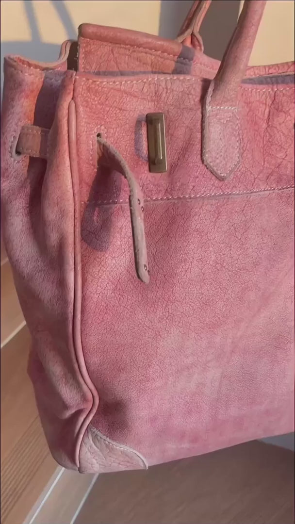 Close-up of the Blossom pink washed leather Firkin bag featuring textured leather, stitched detailing and vintage metal hardware